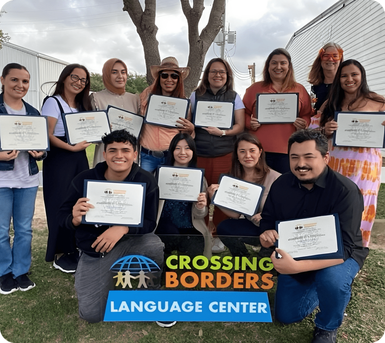 Group holding certificates at Crossing Borders Language Center