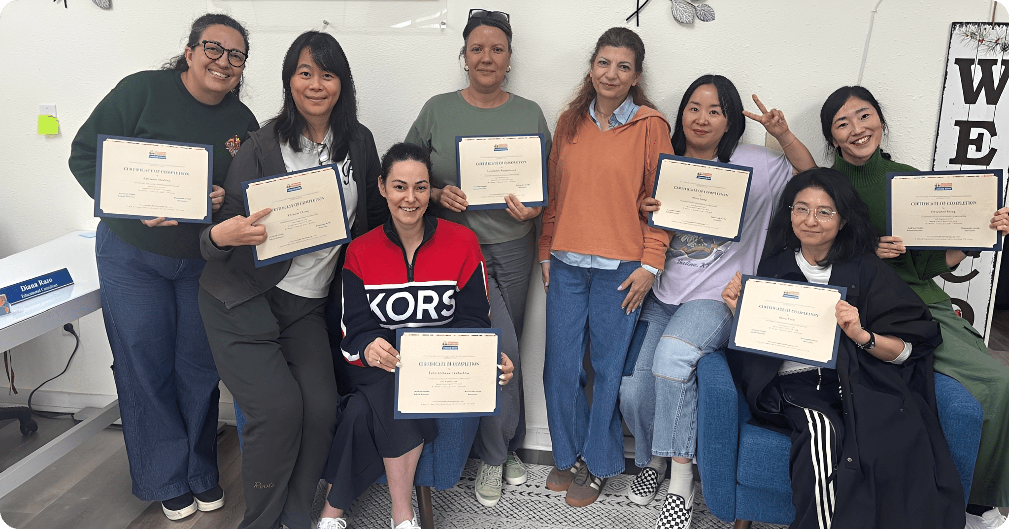 Group of women holding certificates, smiling