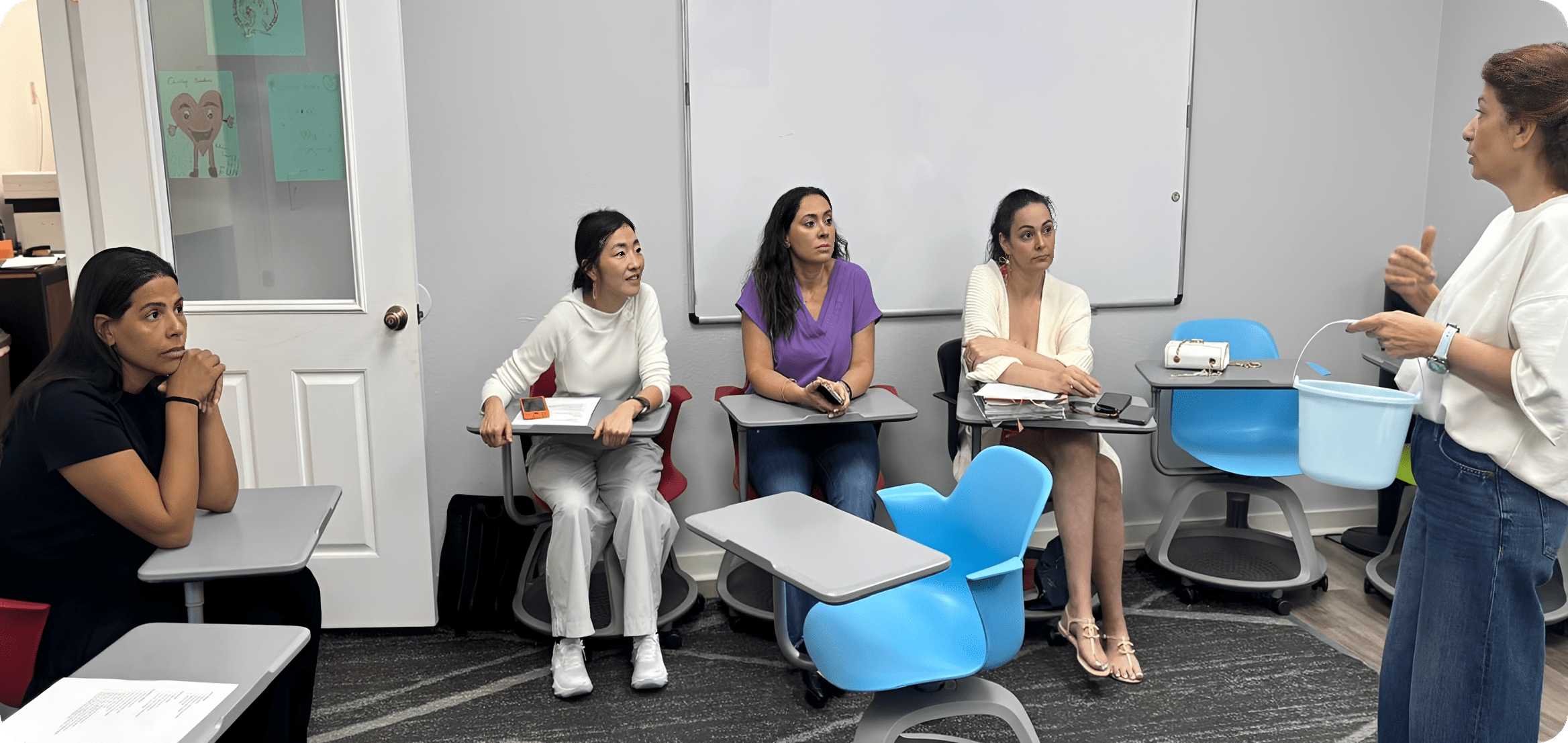 Teacher speaking to adult students in classroom