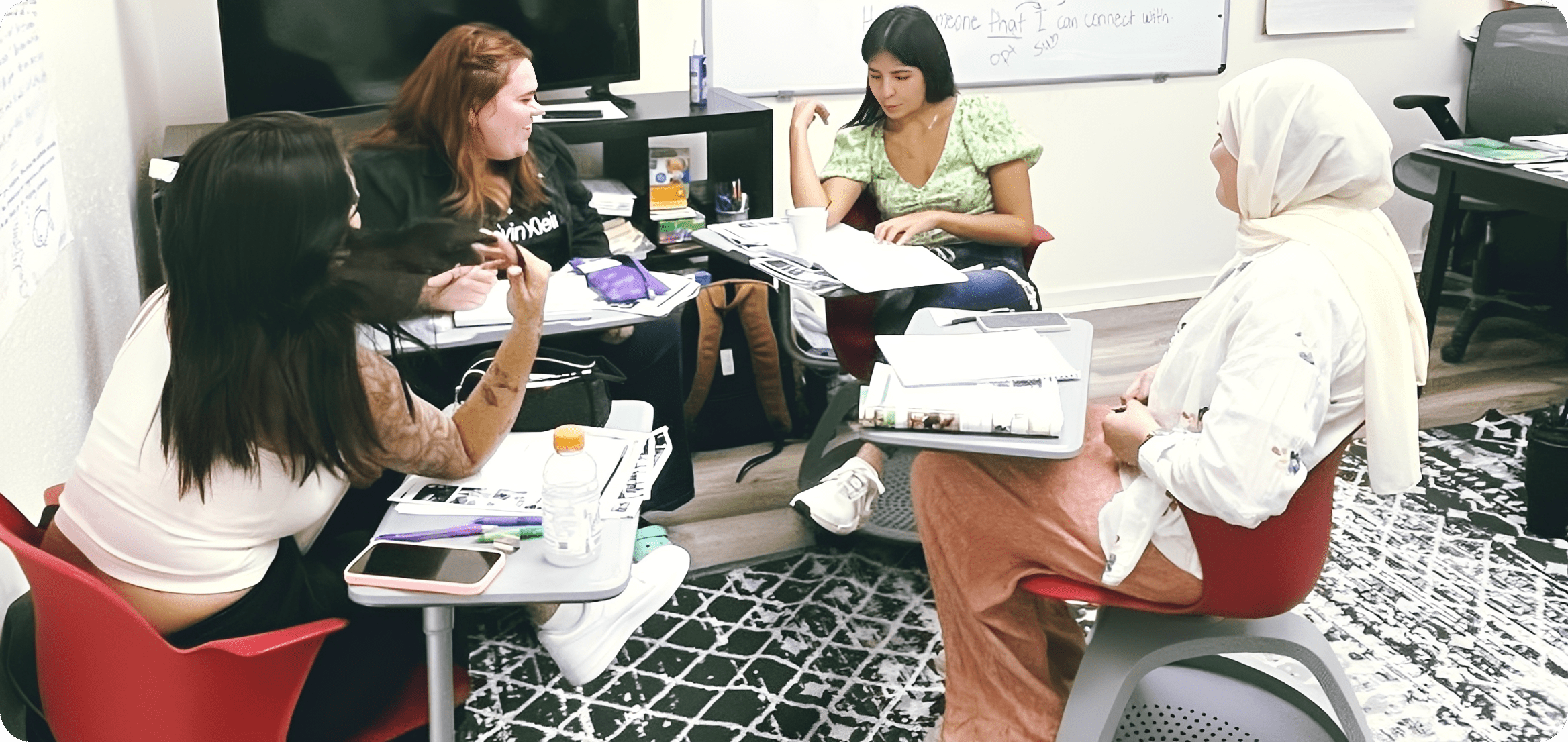 Group of students studying together in classroom